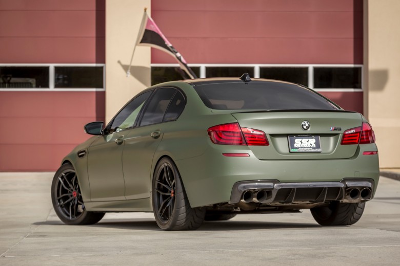 A Military Green BMW M5 With Vorsteiner Wheels And Aero Installed